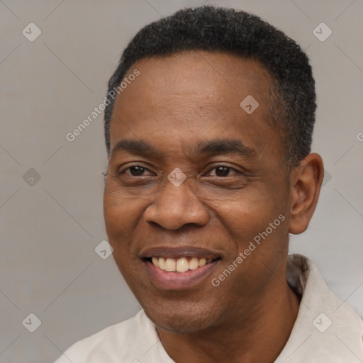 Joyful black adult male with short  black hair and brown eyes