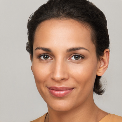 Joyful latino young-adult female with medium  brown hair and brown eyes