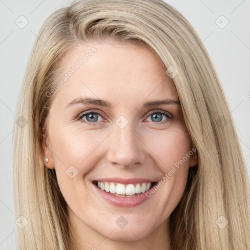 Joyful white young-adult female with long  brown hair and blue eyes