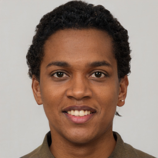 Joyful black young-adult male with short  brown hair and brown eyes