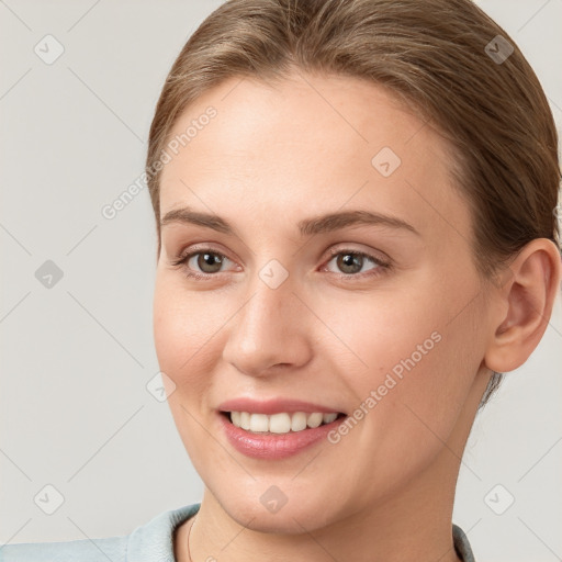 Joyful white young-adult female with short  brown hair and grey eyes