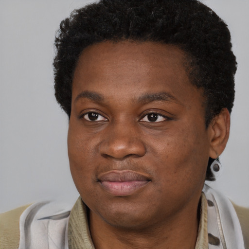 Joyful black young-adult male with short  brown hair and brown eyes