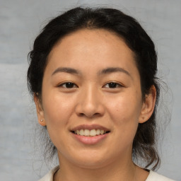 Joyful asian young-adult female with medium  brown hair and brown eyes