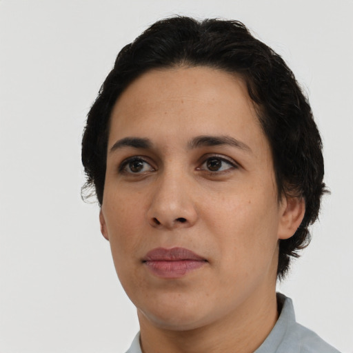 Joyful latino adult female with short  black hair and brown eyes