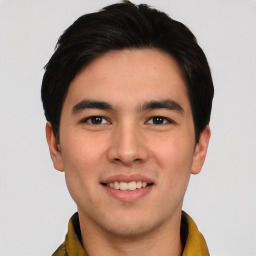 Joyful asian young-adult male with short  black hair and brown eyes