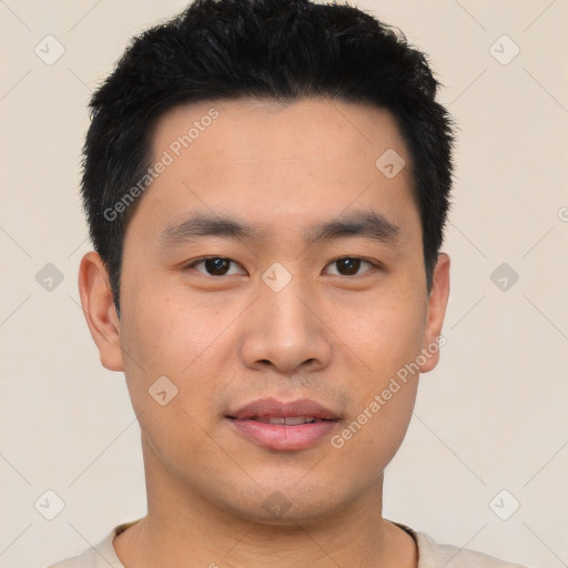 Joyful asian young-adult male with short  black hair and brown eyes