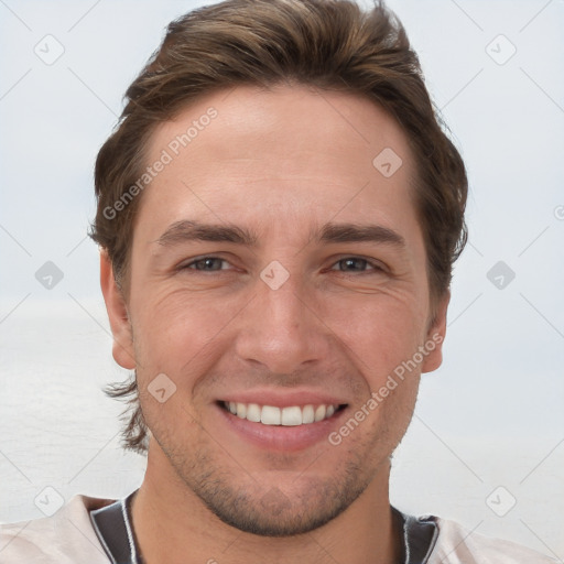 Joyful white young-adult male with short  brown hair and grey eyes