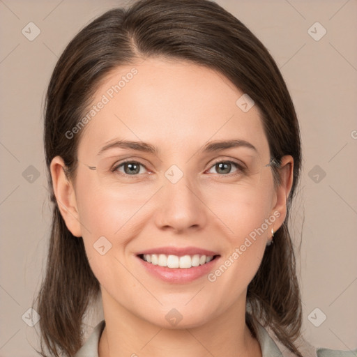 Joyful white young-adult female with medium  brown hair and grey eyes