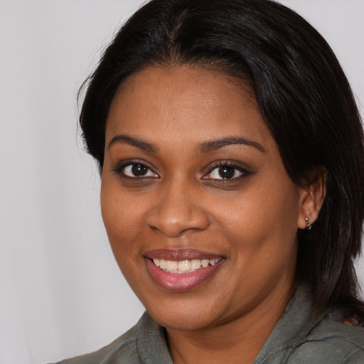 Joyful black young-adult female with medium  brown hair and brown eyes