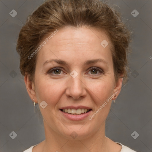 Joyful white adult female with short  brown hair and grey eyes