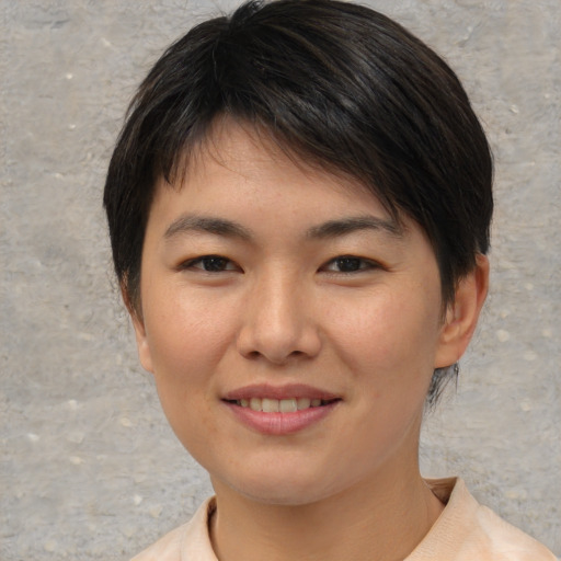 Joyful asian young-adult female with short  brown hair and brown eyes