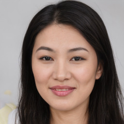 Joyful asian young-adult female with long  brown hair and brown eyes