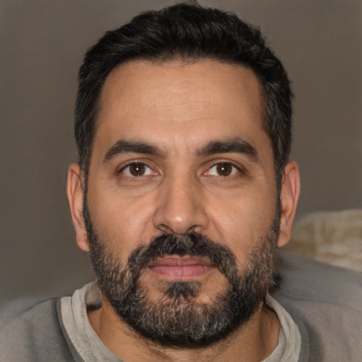 Neutral latino adult male with short  black hair and brown eyes