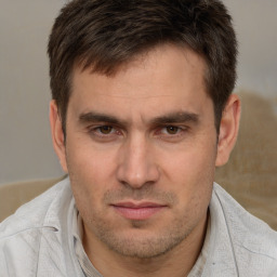 Joyful white adult male with short  brown hair and brown eyes