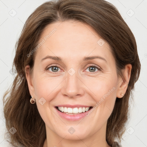 Joyful white adult female with medium  brown hair and grey eyes