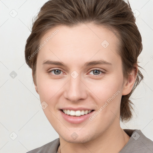 Joyful white young-adult female with medium  brown hair and grey eyes