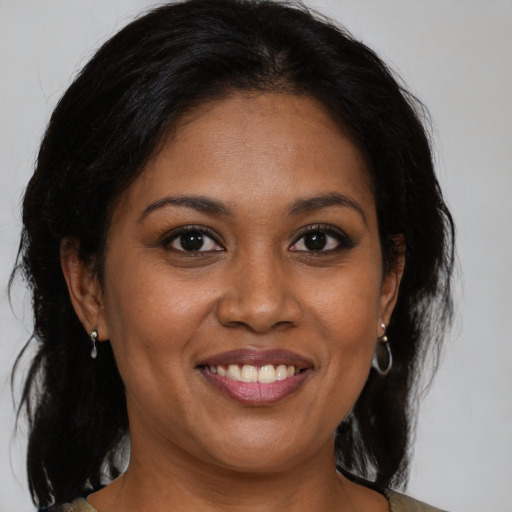 Joyful black young-adult female with medium  brown hair and brown eyes