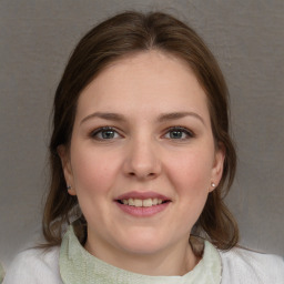 Joyful white young-adult female with medium  brown hair and blue eyes