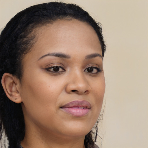 Joyful black young-adult female with long  brown hair and brown eyes