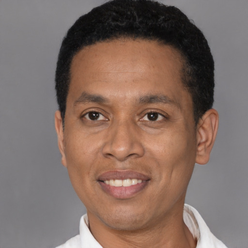 Joyful latino adult male with short  black hair and brown eyes