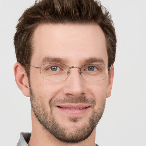 Joyful white adult male with short  brown hair and grey eyes