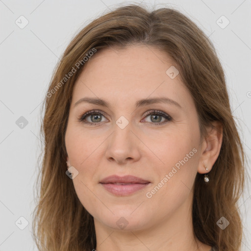 Joyful white adult female with long  brown hair and brown eyes