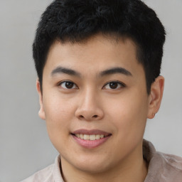 Joyful asian young-adult male with short  brown hair and brown eyes