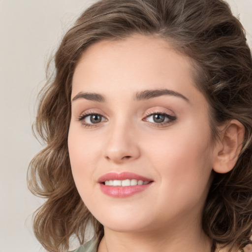 Joyful white young-adult female with long  brown hair and green eyes