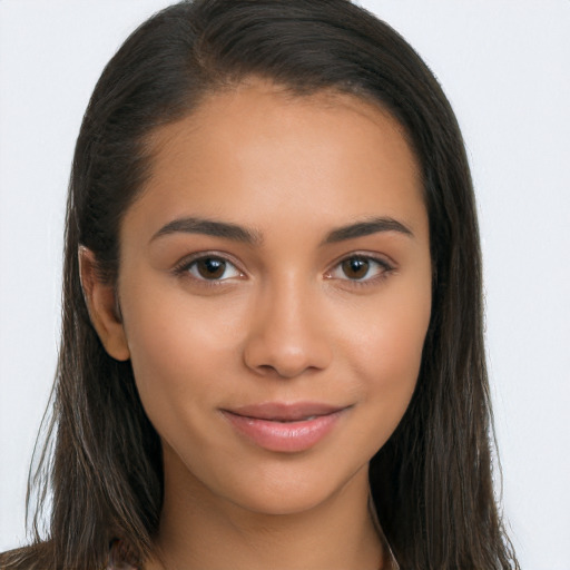 Joyful latino young-adult female with long  brown hair and brown eyes