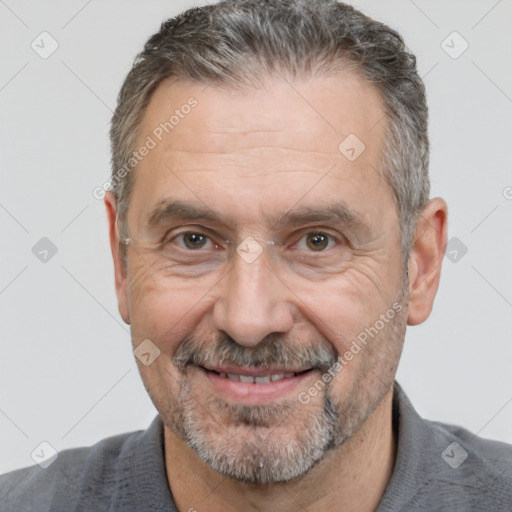 Joyful white middle-aged male with short  brown hair and brown eyes