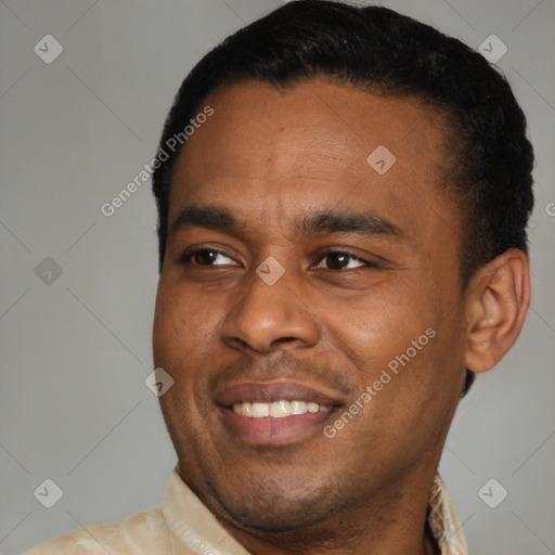 Joyful latino young-adult male with short  black hair and brown eyes