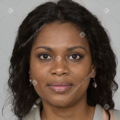 Joyful black adult female with long  brown hair and brown eyes