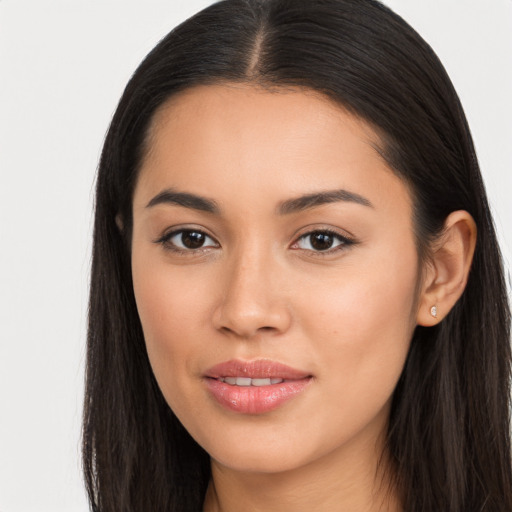 Joyful latino young-adult female with long  brown hair and brown eyes