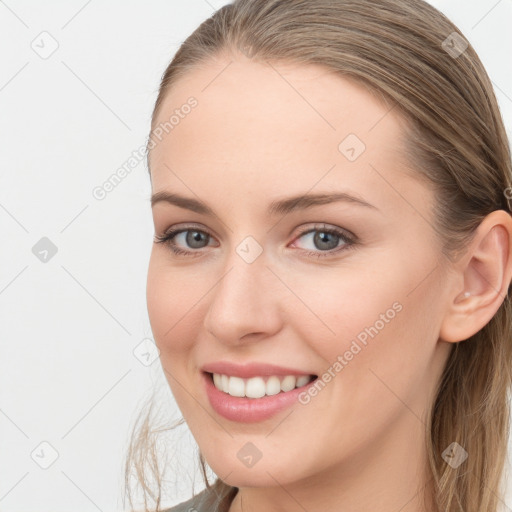 Joyful white young-adult female with long  brown hair and blue eyes