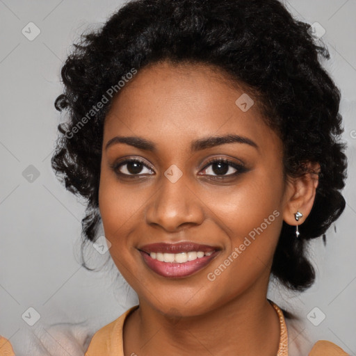 Joyful black young-adult female with long  black hair and brown eyes