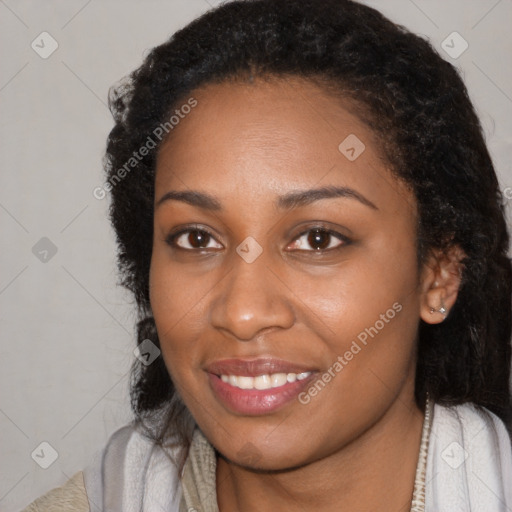 Joyful black young-adult female with long  black hair and brown eyes