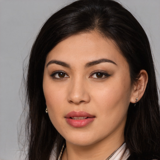 Joyful latino young-adult female with long  brown hair and brown eyes