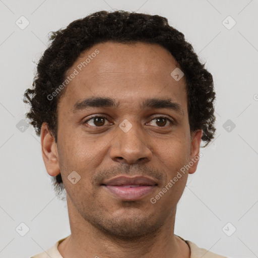 Joyful black young-adult male with short  brown hair and brown eyes