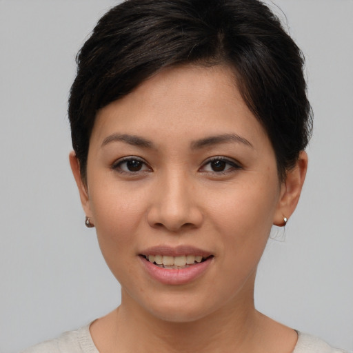 Joyful asian young-adult female with short  brown hair and brown eyes