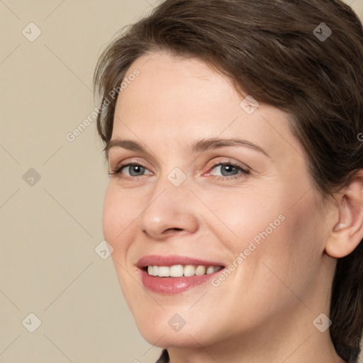 Joyful white adult female with medium  brown hair and grey eyes