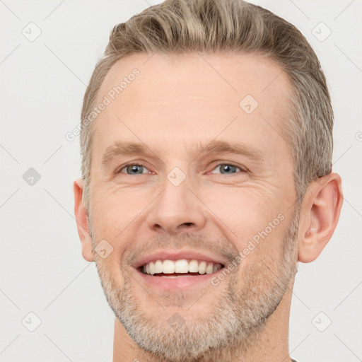 Joyful white adult male with short  brown hair and grey eyes