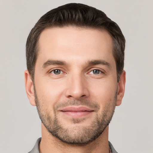 Joyful white young-adult male with short  brown hair and brown eyes