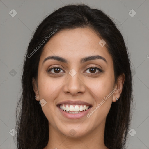 Joyful latino young-adult female with long  brown hair and brown eyes