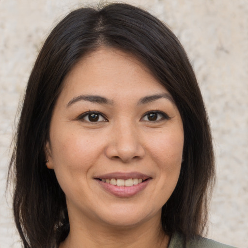 Joyful asian young-adult female with medium  brown hair and brown eyes