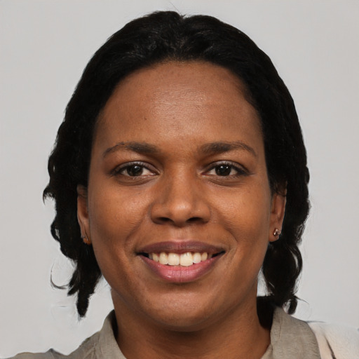 Joyful black young-adult female with medium  black hair and brown eyes