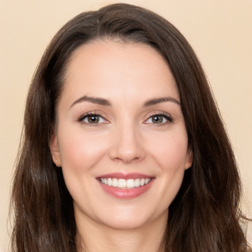 Joyful white young-adult female with long  brown hair and brown eyes