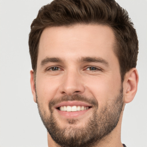 Joyful white young-adult male with short  brown hair and brown eyes