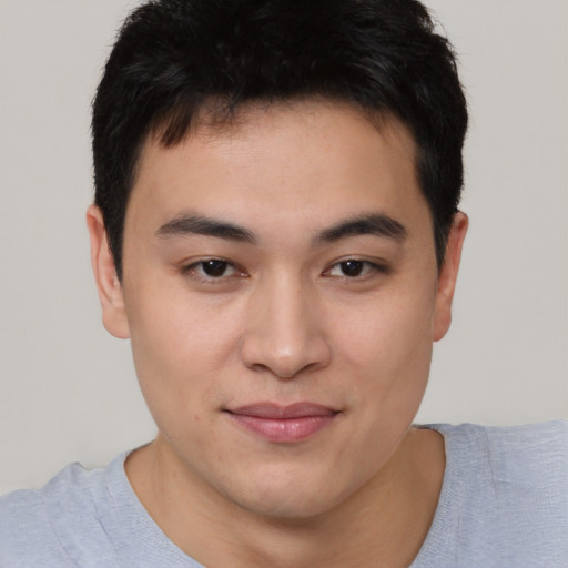 Joyful asian young-adult male with short  brown hair and brown eyes