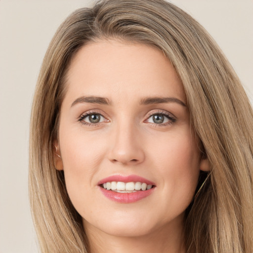 Joyful white young-adult female with long  brown hair and green eyes