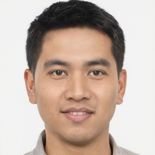 Joyful asian young-adult male with short  black hair and brown eyes
